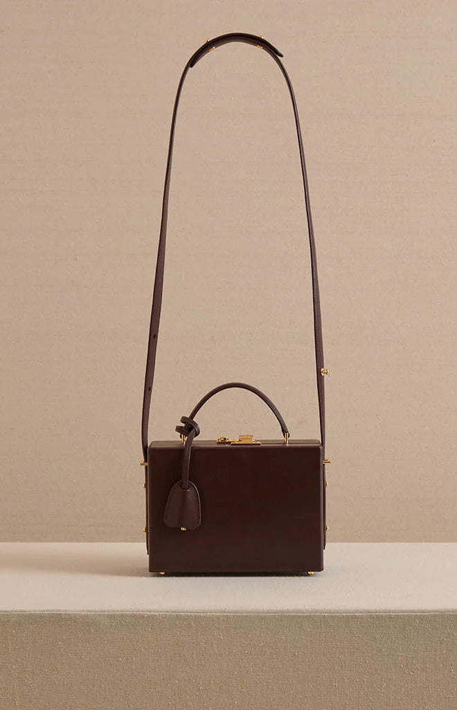 Front view of Grace 18 box bag in smooth calf chocolate with top handle, long shoulder strap, and gold hardware