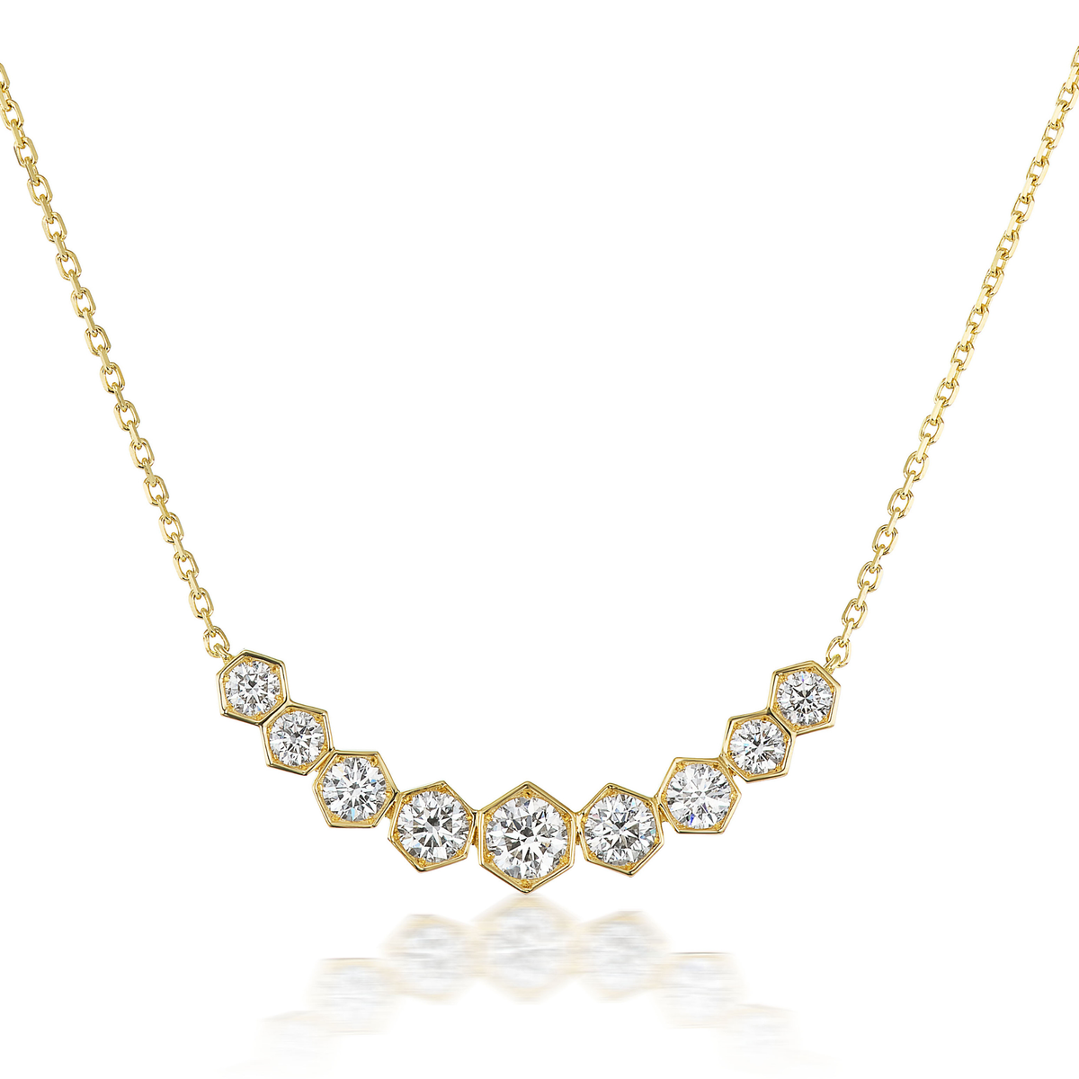 The Bezel Set Hexagon Necklace with Graduated Brilliant Diamonds features an 18k gold V-shaped pendant with nine hexagonal settings, each holding a brilliant round diamond in decreasing size from center to edges—perfect for any occasion.