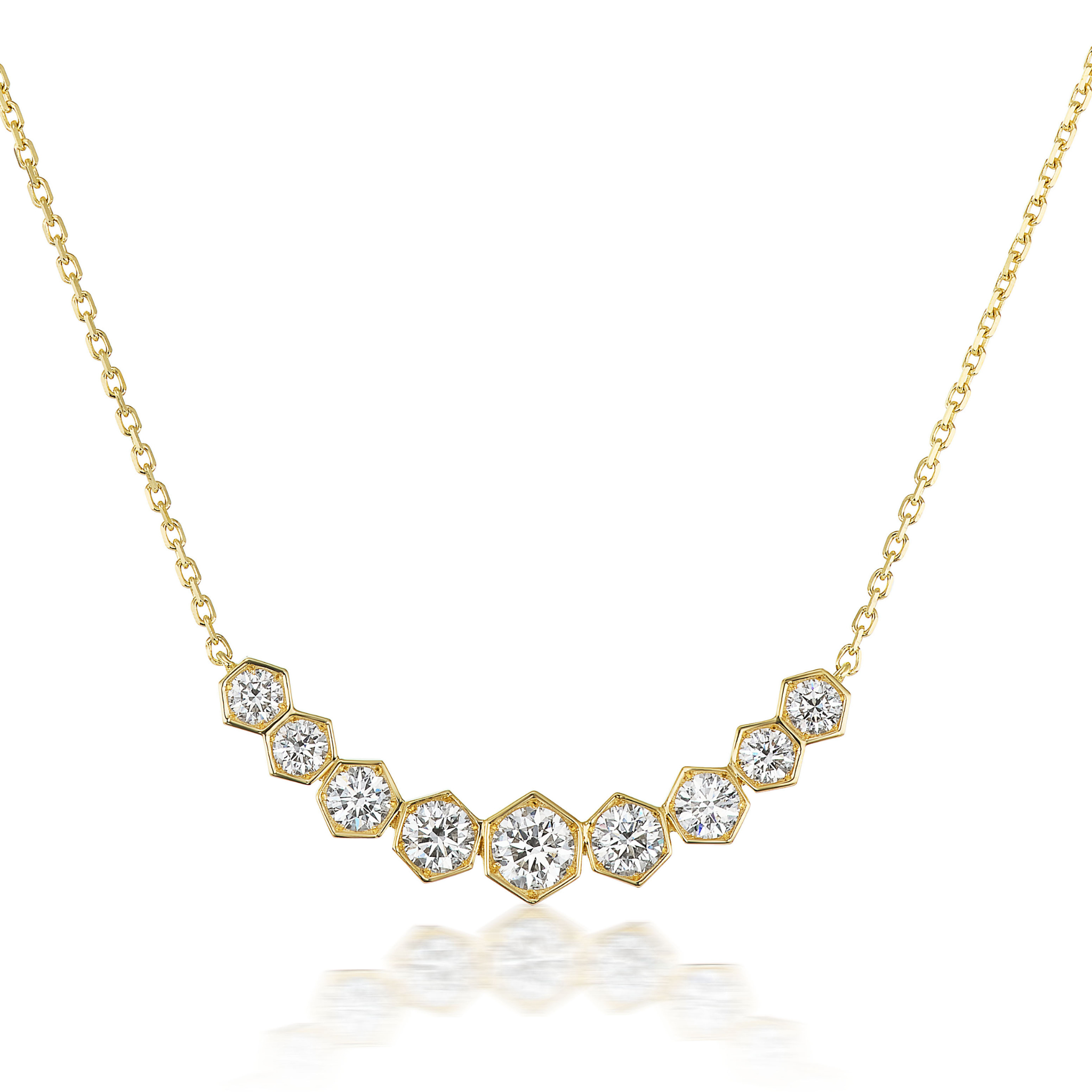 The Bezel Set Hexagon Necklace with Graduated Brilliant Diamonds features an 18k gold V-shaped pendant with nine hexagonal settings, each holding a brilliant round diamond in decreasing size from center to edges—perfect for any occasion.