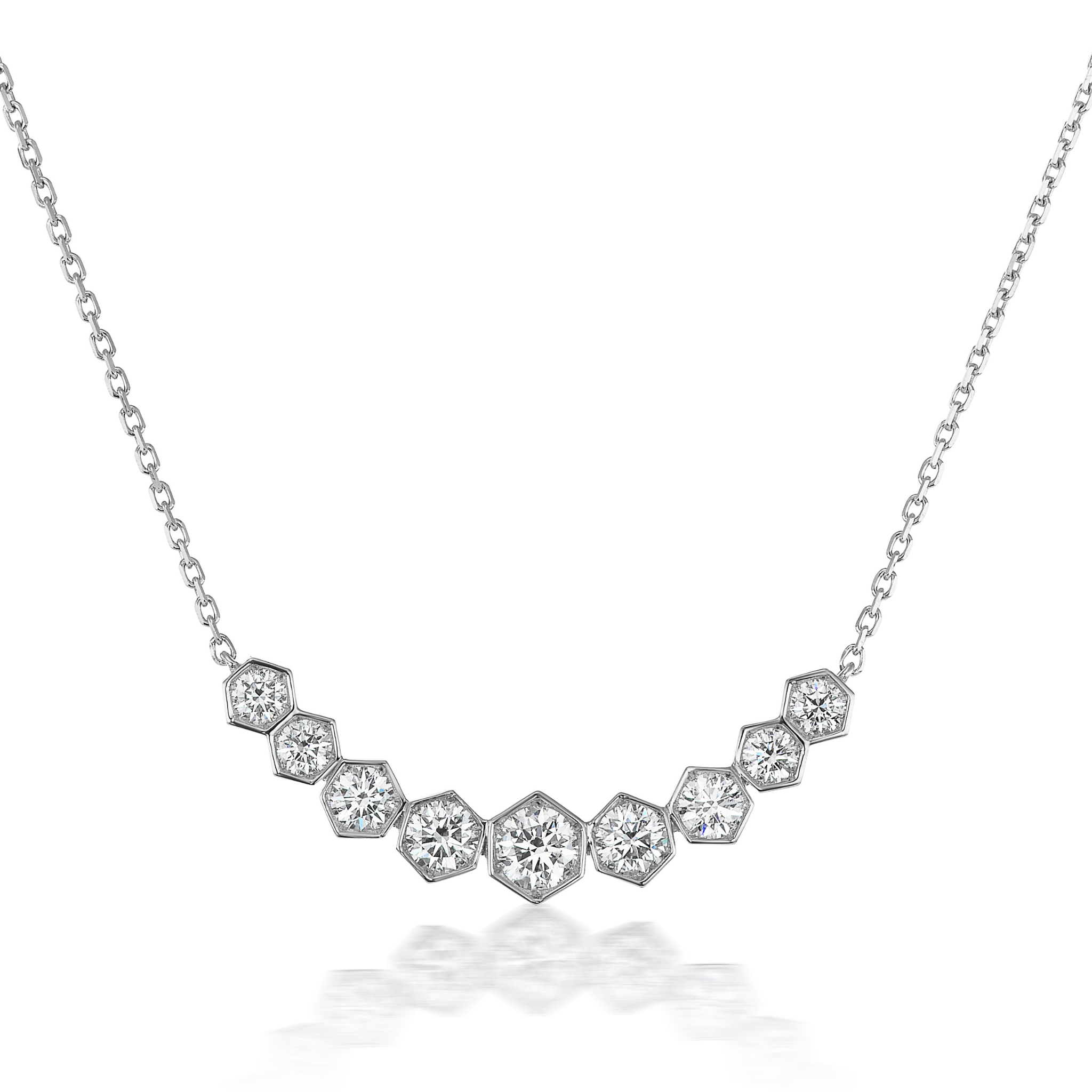 The Bezel Set Hexagon Necklace with Graduated Brilliant Diamonds features a chain with hexagonal settings, each holding a sparkling round diamond in an elegant curve—an 18k gold necklace perfect for any occasion.
