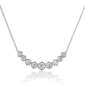 The Bezel Set Hexagon Necklace with Graduated Brilliant Diamonds features a chain with hexagonal settings, each holding a sparkling round diamond in an elegant curve—an 18k gold necklace perfect for any occasion.