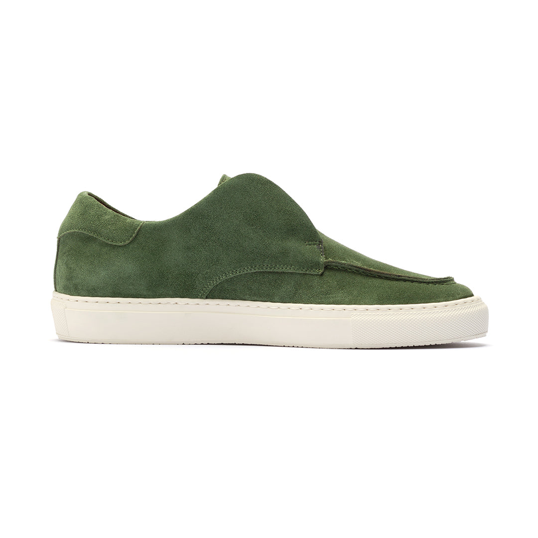 Side view of men’s green suede Pitti sneaker showcasing its hand-stitched rubber sneaker sole on a white background