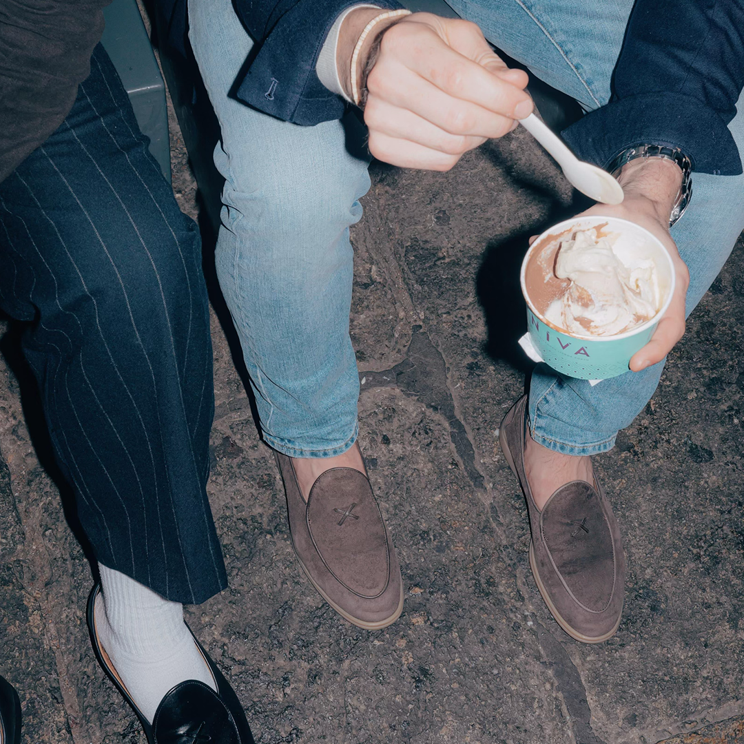 People wearing Grigio Suede Viaggio loafers while sharing gelato outdoors