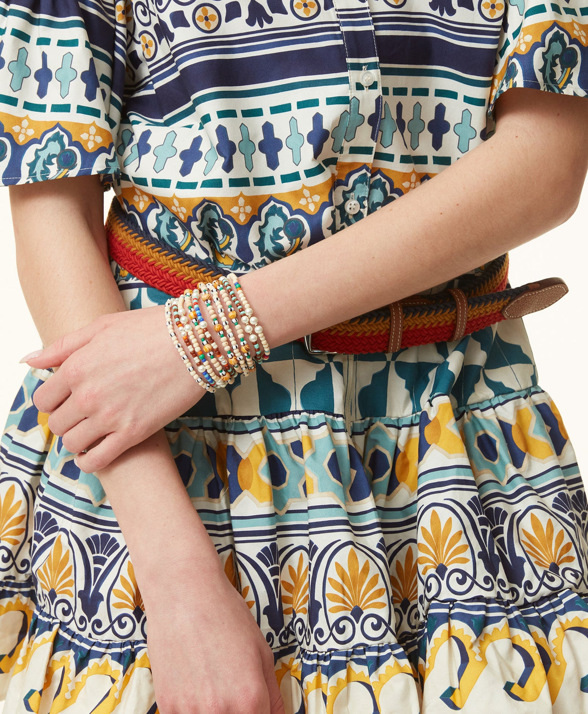 Close-up of Life’s a Beach Bunch showcasing five colorful beaded stretch bracelets on a wrist against patterned clothing