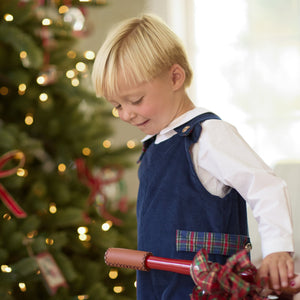 Front view of Louis Longall in Midnight Blue Corduroy showing Tinsel Tartan trim on a child with a Christmas tree background