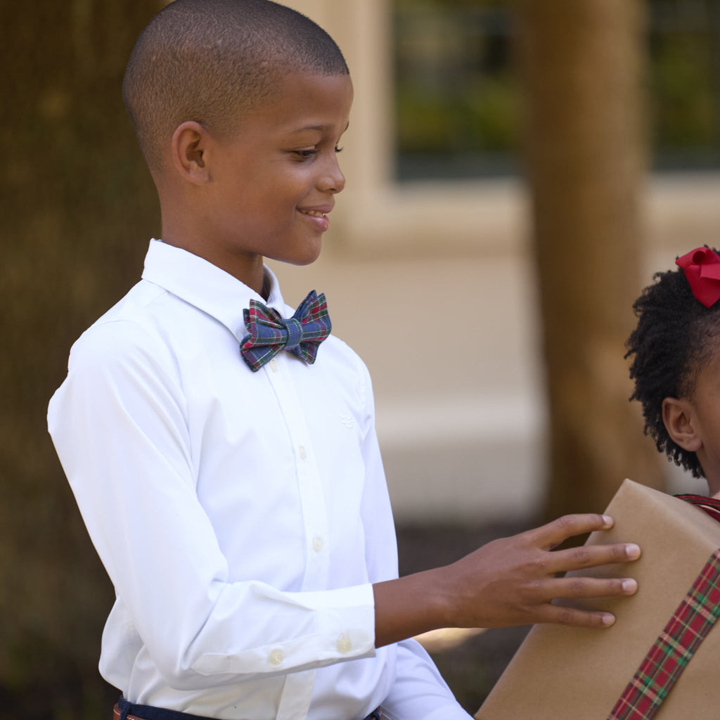 Boys’ pre-tied Baker Bow Tie in navy, red, and green Tinsel Tartan with subtle metallic thread and easy-on clasp.