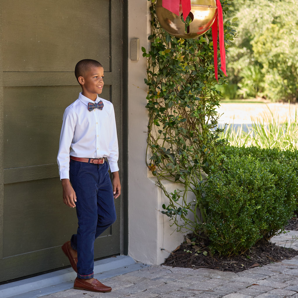 Front view of Boys’ Bradford Trousers in Midnight Blue Corduroy showcasing the fit on a child outside a home