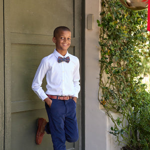 Front view of Boys’ Bradford Trousers in Midnight Blue Corduroy showing fit on a child by a doorway