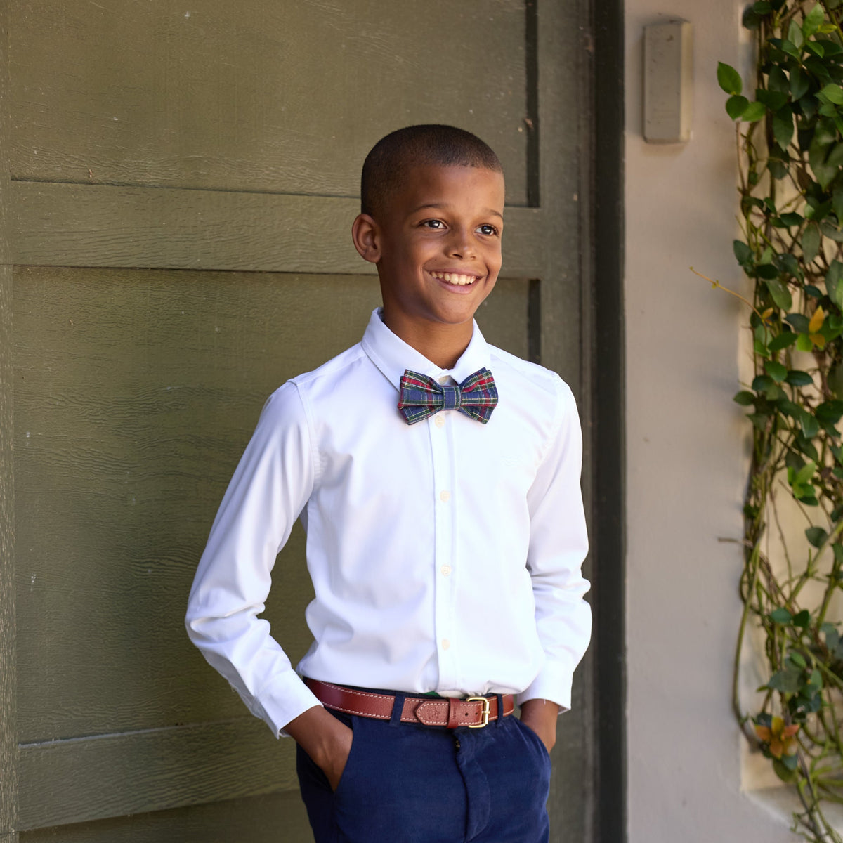 Boys’ pre-tied Baker Bow Tie in navy, red, and green Tinsel Tartan with subtle metallic thread and easy-on clasp.