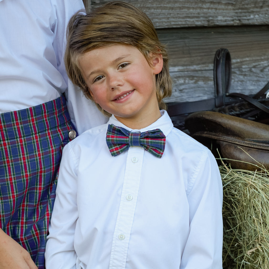 Boys’ pre-tied Baker Bow Tie in navy, red, and green Tinsel Tartan with subtle metallic thread and easy-on clasp.