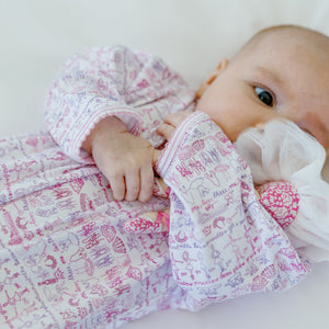 Close-up of a baby wearing the pink Ballet Snap Baby Onesie showcasing its ballet print with a light background