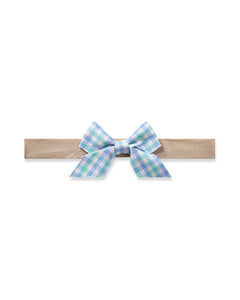 The Girls Twill Hair Bow in Spring Gingham by Petite Plume is a stylish accessory featuring a blue and green checkered pattern on a light brown band, elegantly displayed against a plain white background, making it a versatile addition to any wardrobe.