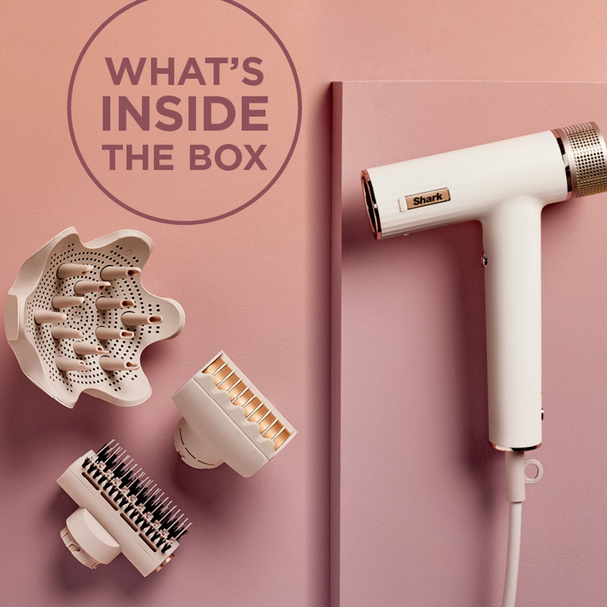 Right-side view of Shark RapidGloss hair dryer with attachments on pink background, overlay text ‘WHAT’S INSIDE THE BOX’