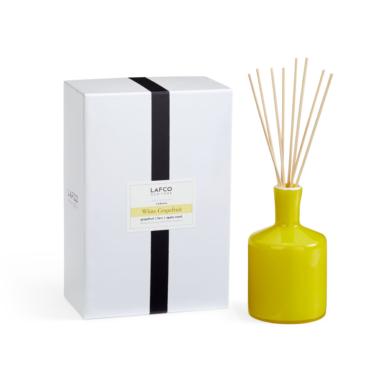 Front view of White Grapefruit Signature Reed Diffuser showing yellow glass vessel, reeds, and boxed packaging on a white background