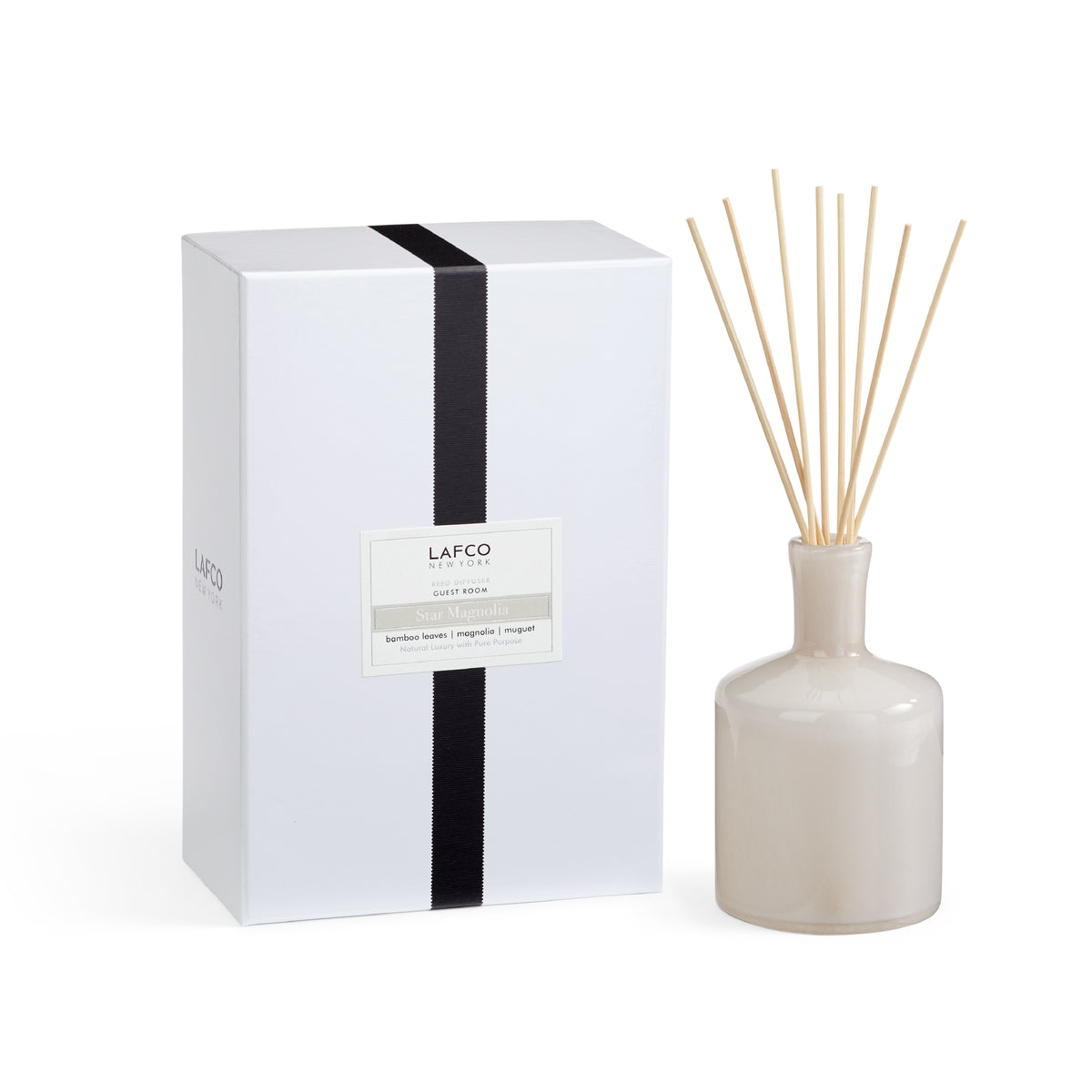 Front view of Star Magnolia Signature Reed Diffuser showcasing its bottle, reeds, and gift box on a white background