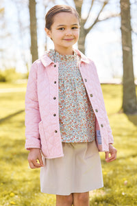 Little english classic childrens clothing, quilted jacket in light pink, hallie top in orange, blue, and green james floral, paperbag bow skirt in stone corduroy 