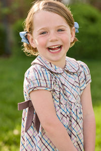 Little English traditional children's clothing. Short sleeve peter pan dress in blue, pink, and brown Wilmington Plaid with brown corduroy piping and bow details for little girls.