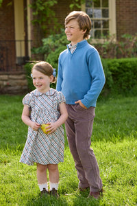 Little English traditional children's clothing. Boys stormy blue quarter zip sweater layered over blue, pink, and brown Wilmington Plaid button down shirt and paired with chocolate brown corduroy classic pants.  Short sleeve peter pan dress in blue, pink, and brown Wilmington Plaid with brown corduroy details for little girls.
