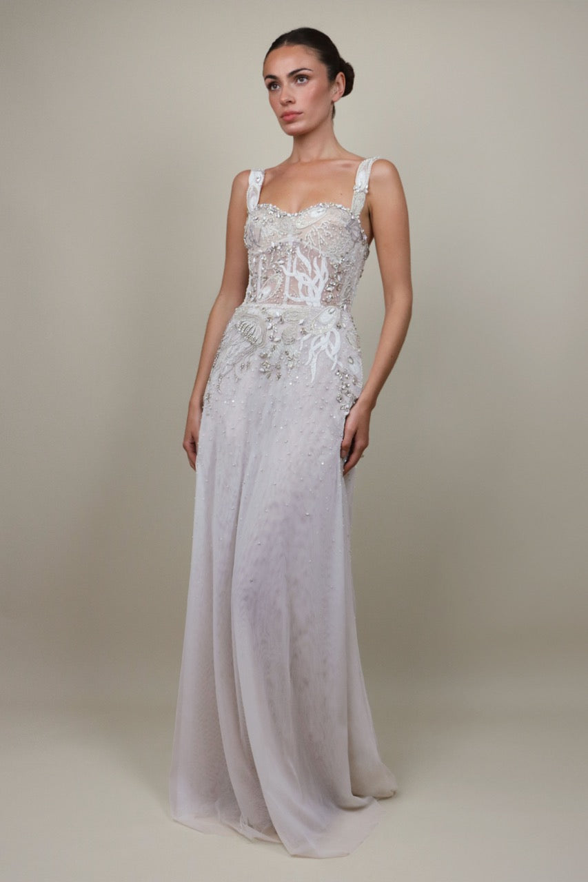 Front view of Celestial Seascape Bustier Gown showcasing beaded bustier, sheer panels and flowing skirt on neutral background