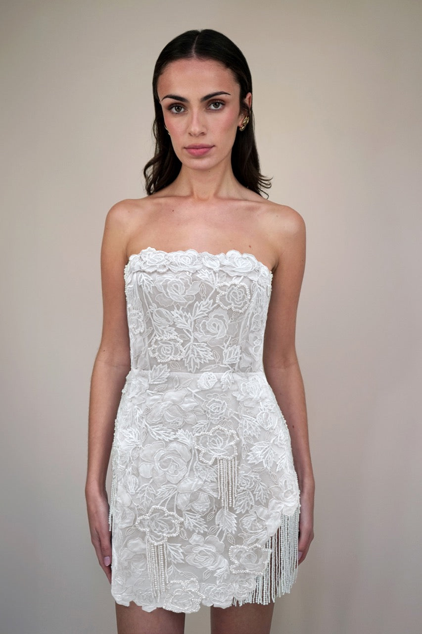Front view of Wild Rose Pearl Tassel Mini strapless fitted dress on model with floral lace embroidery and pearl tassel fringe