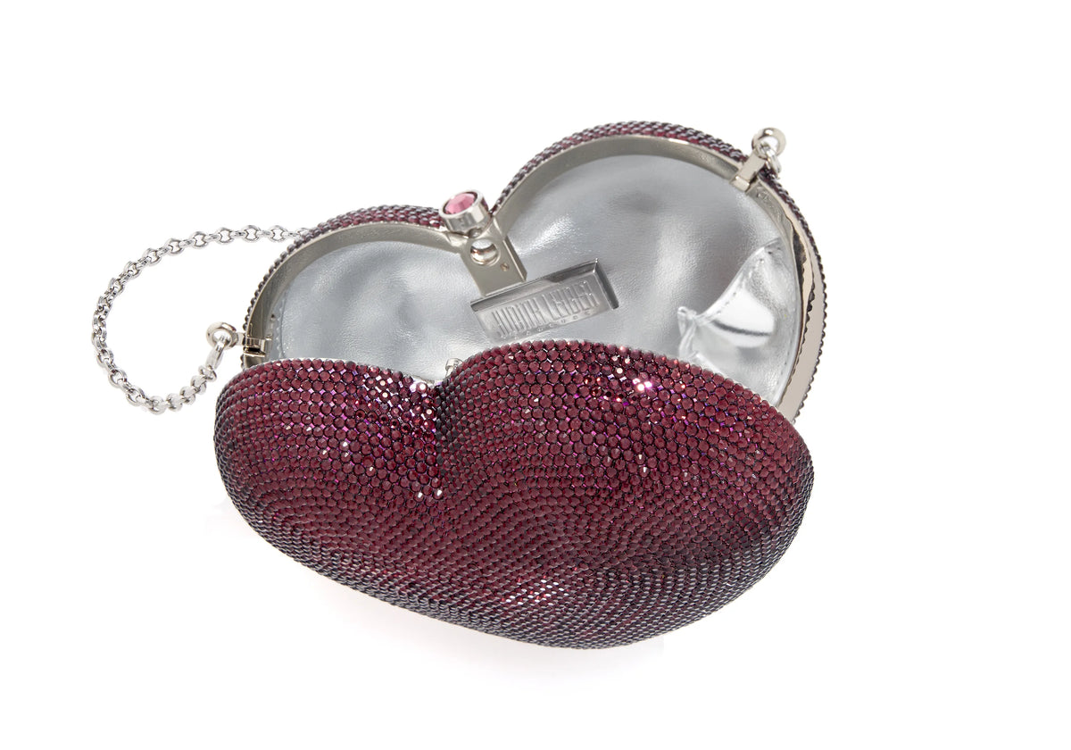 Angled view of Petit Coeur Lamour heart-shaped amethyst crystal clutch with open silver interior and chain on white