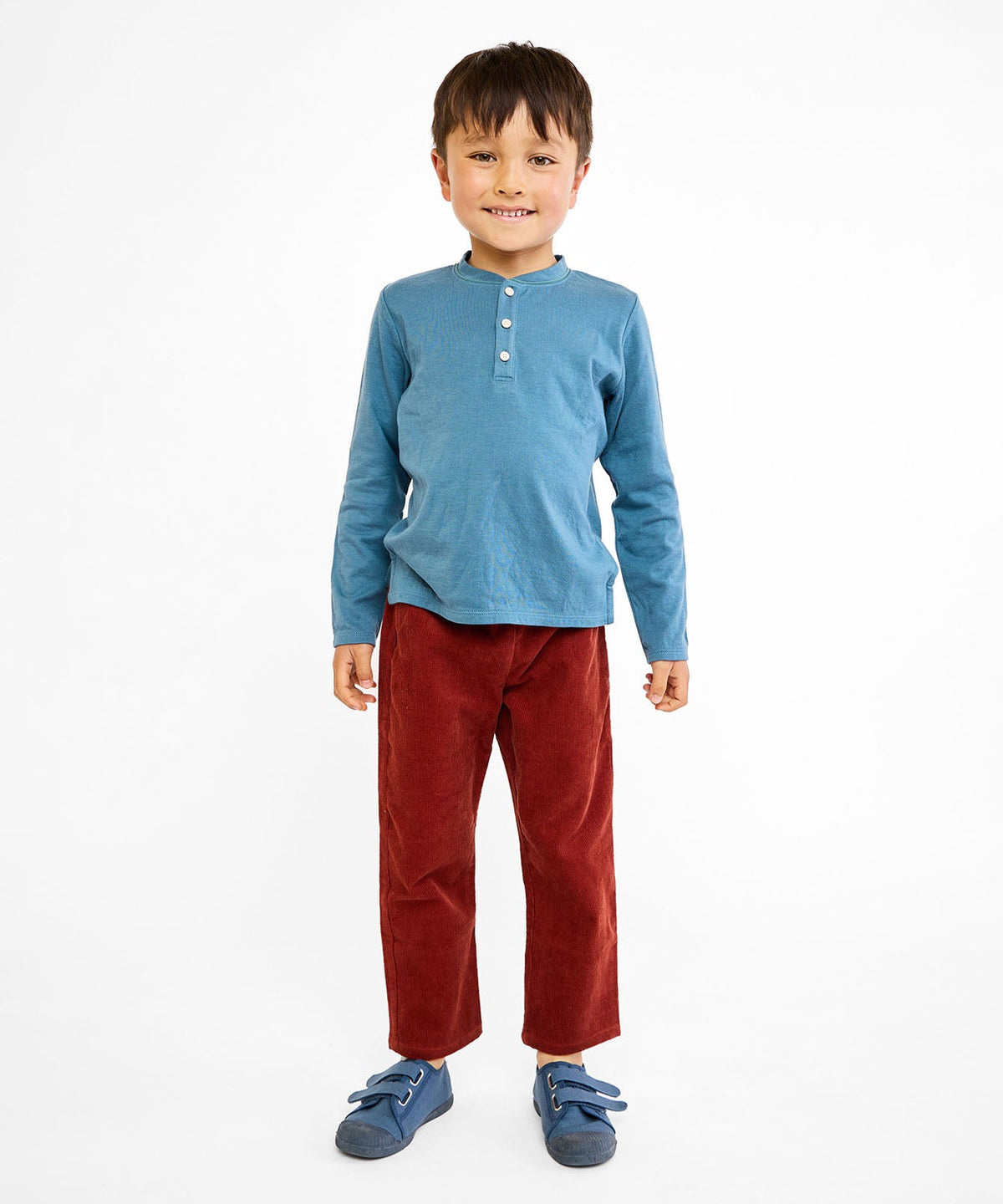 Front view of Henley T-Shirt in Petrol with long sleeves and stacked buttons on a child showing a true-to-size fit against white