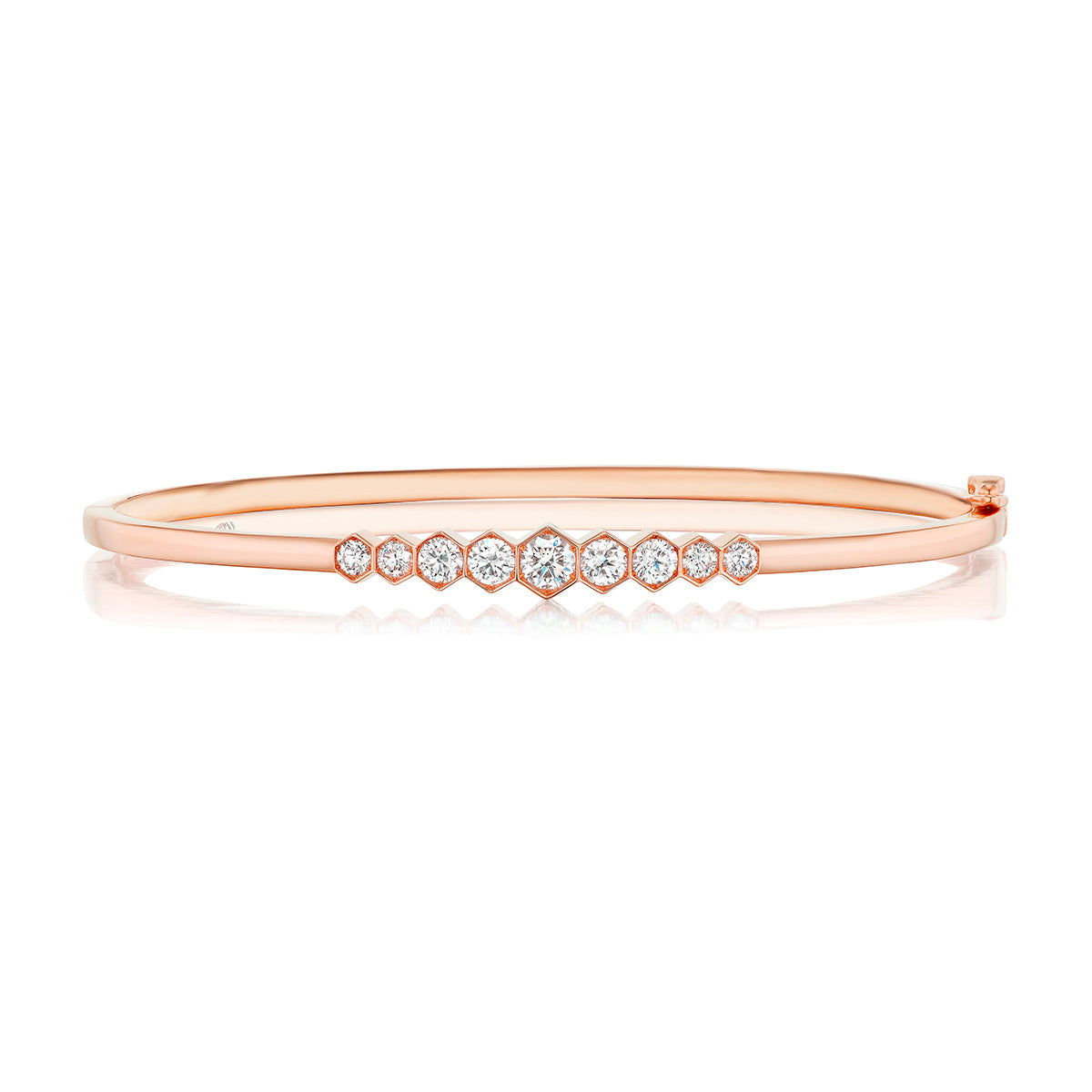 The Graduated Hexagon Bezel Set Diamond Bangle features round white diamonds in graduated sizes, set in 18k rose gold with a sleek, polished finish and minimalist, elegant style.