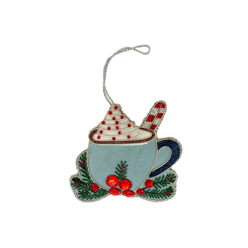 Front view of Holiday Hot Chocolate ornament showcasing hand-beaded whipped cream, candy cane, embroidered greenery, red sequins, and silver hanging loop on white background