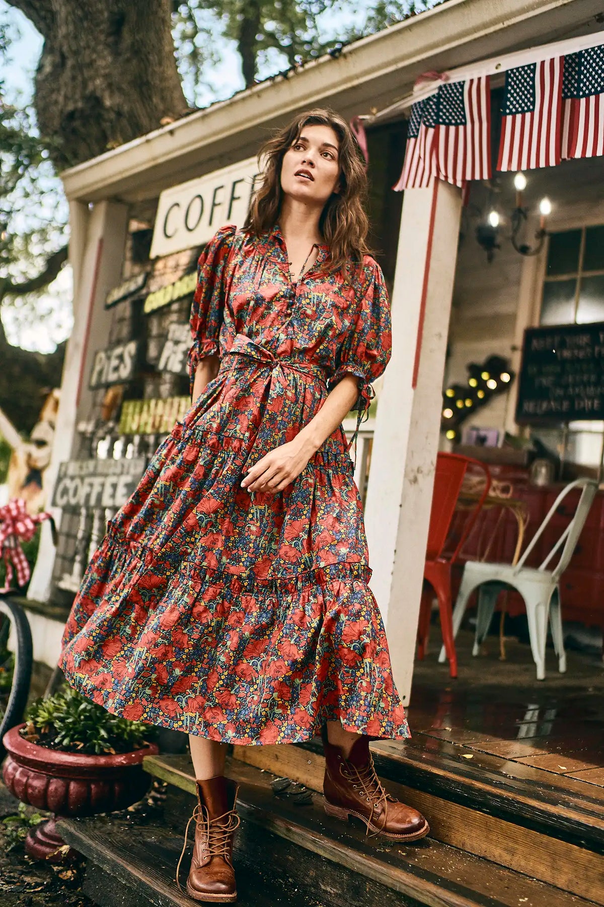 The Holloway Dress has v-neck, elbow-length puff sleeves, tiered ruffled seams and an optional sash.