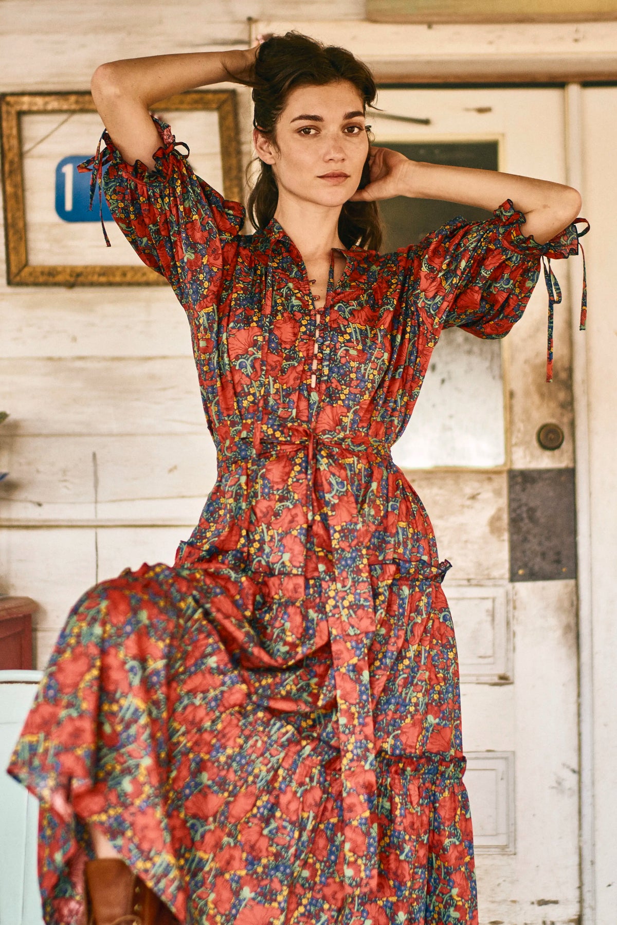 The Holloway Dress has v-neck, elbow-length puff sleeves, tiered ruffled seams and an optional sash.