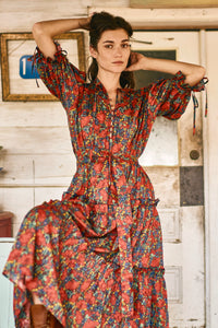 The Holloway Dress has v-neck, elbow-length puff sleeves, tiered ruffled seams and an optional sash.