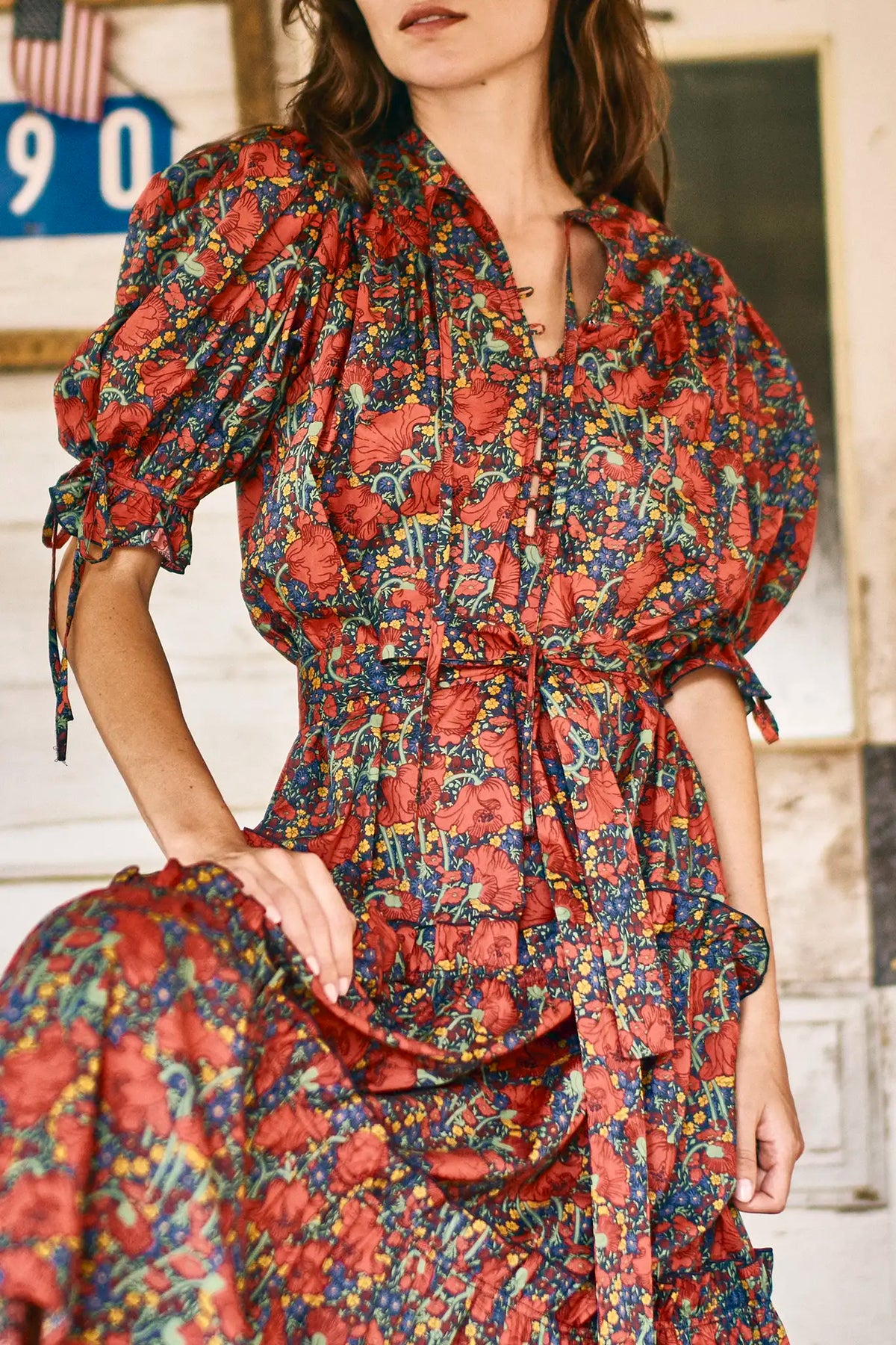 The Holloway Dress has v-neck, elbow-length puff sleeves, tiered ruffled seams and an optional sash.