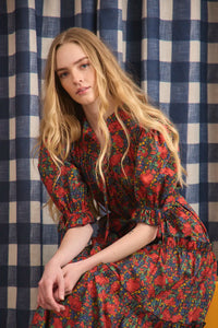 The Holloway Dress has v-neck, elbow-length puff sleeves, tiered ruffled seams and an optional sash.