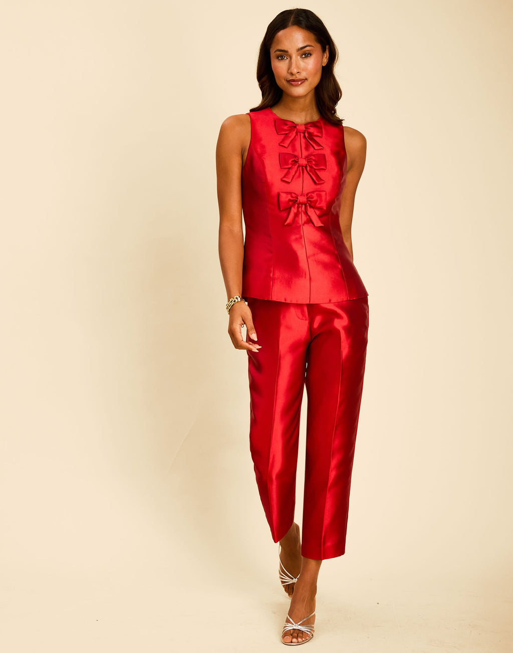 Hudson Bow Top in Merlot Red with a sleeveless crew neckline, three bows down the front, and peplum silhouette.
