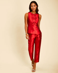 Hudson Bow Top in Merlot Red with a sleeveless crew neckline, three bows down the front, and peplum silhouette.
