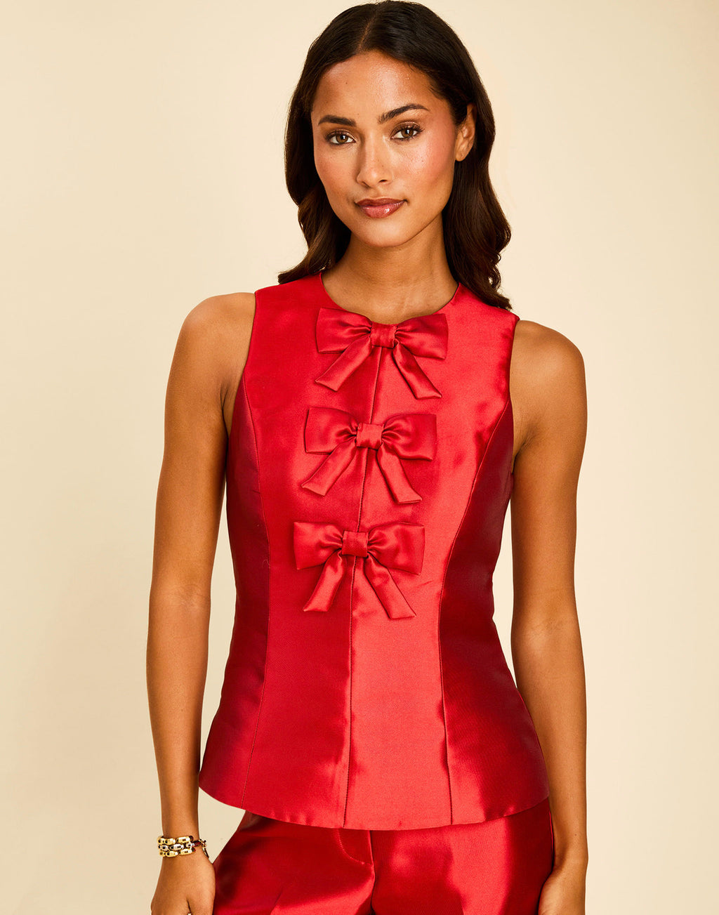 Hudson Bow Top in Merlot Red with a sleeveless crew neckline, three bows down the front, and peplum silhouette.
