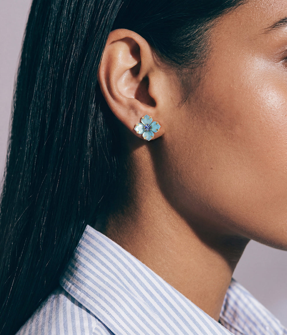 Side view of Hydrangea Studs in aqua showing four glass teardrop petals and faceted crystal center on a model’s ear