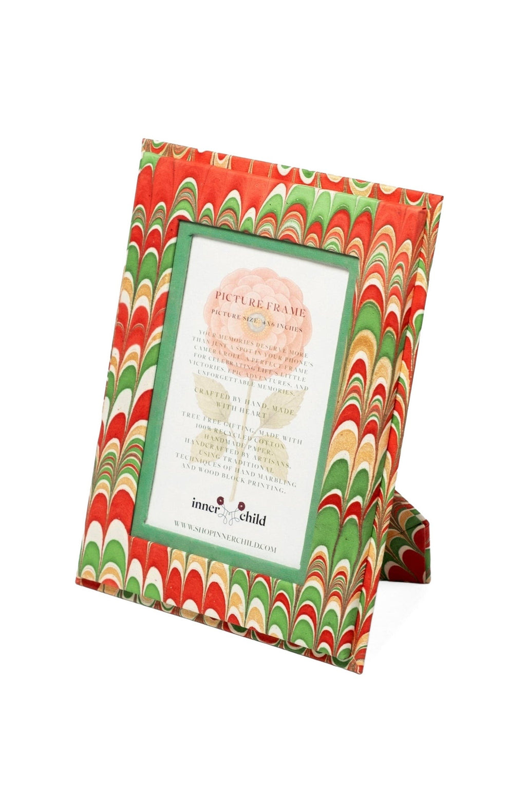 Angled view of Hand-Marbled 4x6 Picture Frame in Holiday Jingle showcasing red, green and gold marbling with white background