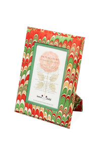 Angled view of Hand-Marbled 4x6 Picture Frame in Holiday Jingle showcasing red, green and gold marbling with white background