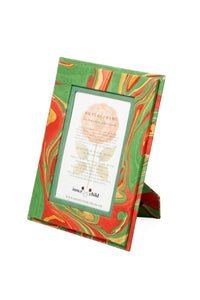 Front three-quarter view of Hand-Marbled 4x6 Picture Frame in Holiday Wave showcasing green, red, and gold swirls with a white background