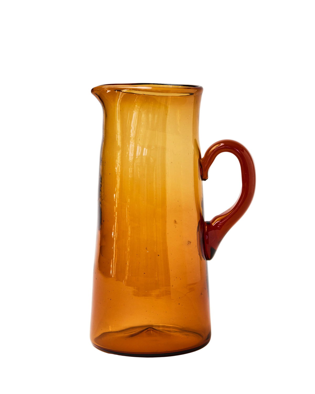 Front view of Pienza carafe showing amber hand-blown glass, curved handle, and spout on white background