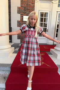 The Joy Kids Dress has a black velvet Peter Pan collar, smocked bodice, and puff short sleeves.