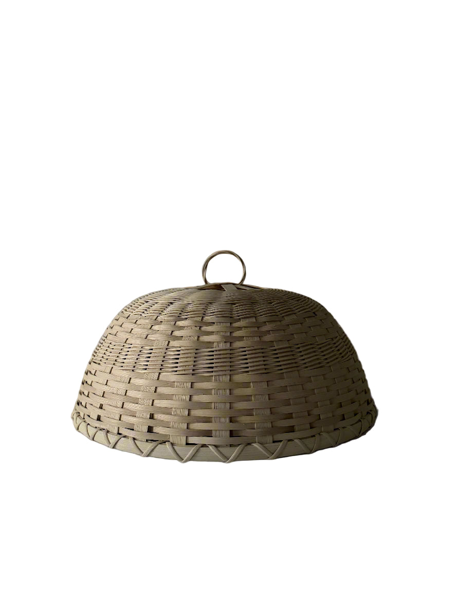 Front view of Folk Fleur Cloche in Natural showcasing handwoven natural rattan dome and loop handle on white background