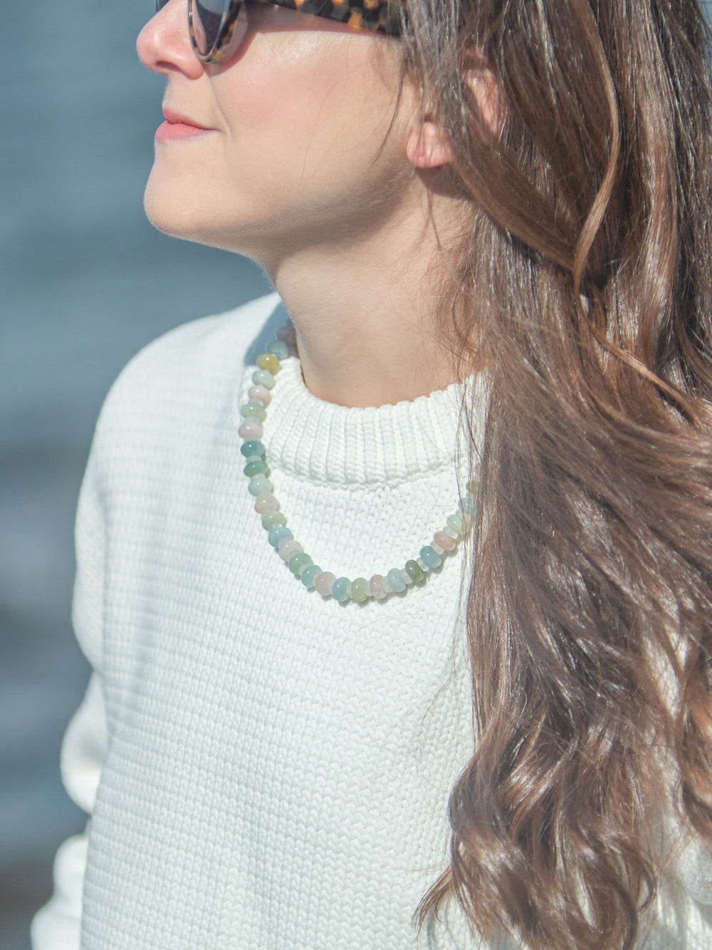 Close-up of Martha Necklace in Multi showcasing pastel gemstones and freshwater pearl charm on a model