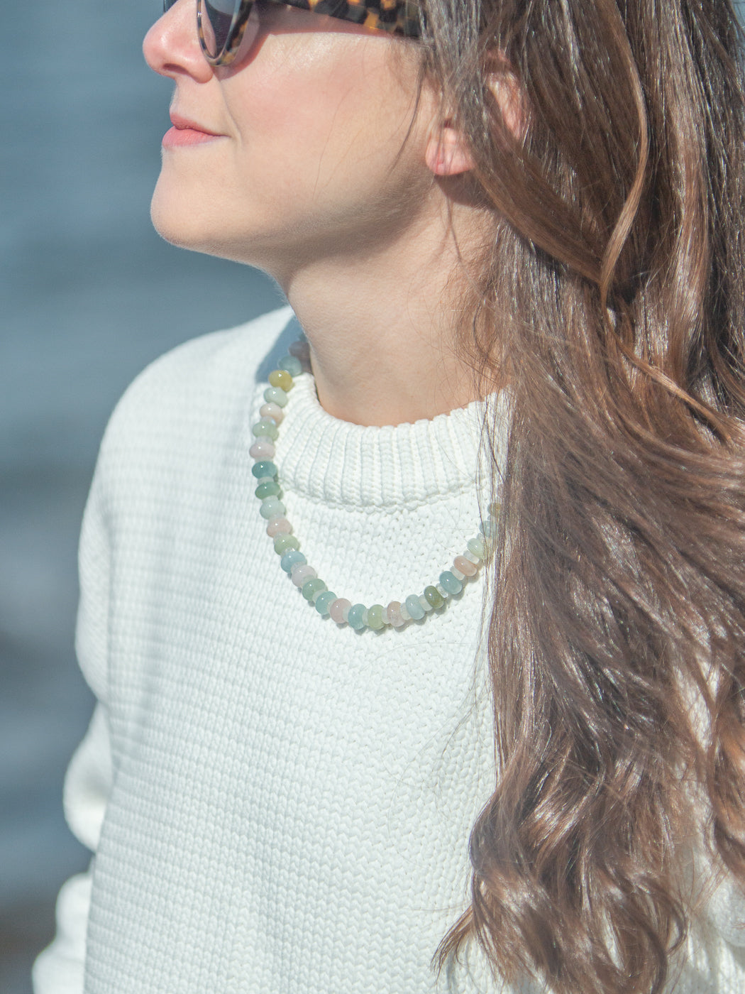 Close-up of Martha Necklace in Multi showcasing pastel gemstones and freshwater pearl charm on a model
