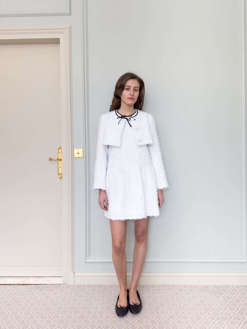 Front view of Leandra Jacket in Ciel on model, cropped white tweed with grosgrain bow at neckline and covered buttons