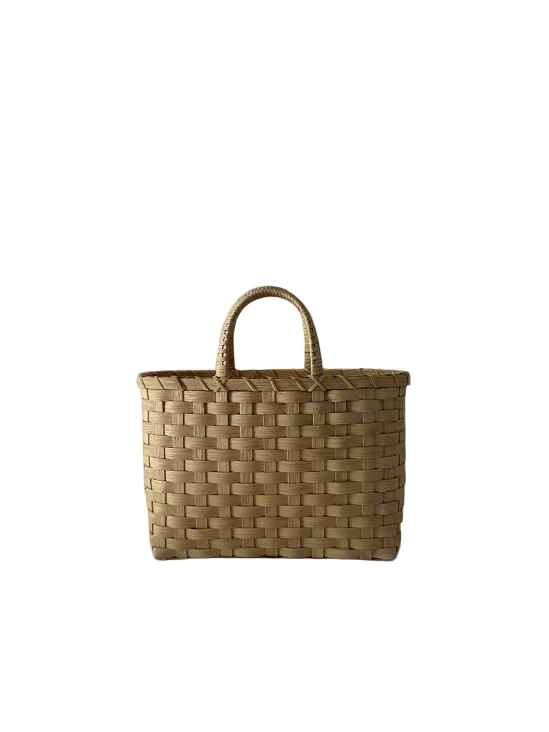 Woven basket with handles on a gray background