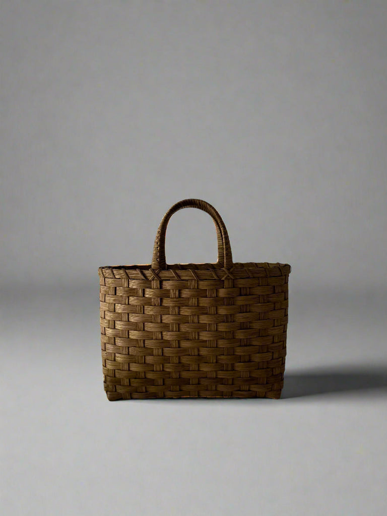 Woven brown bag on a gray background