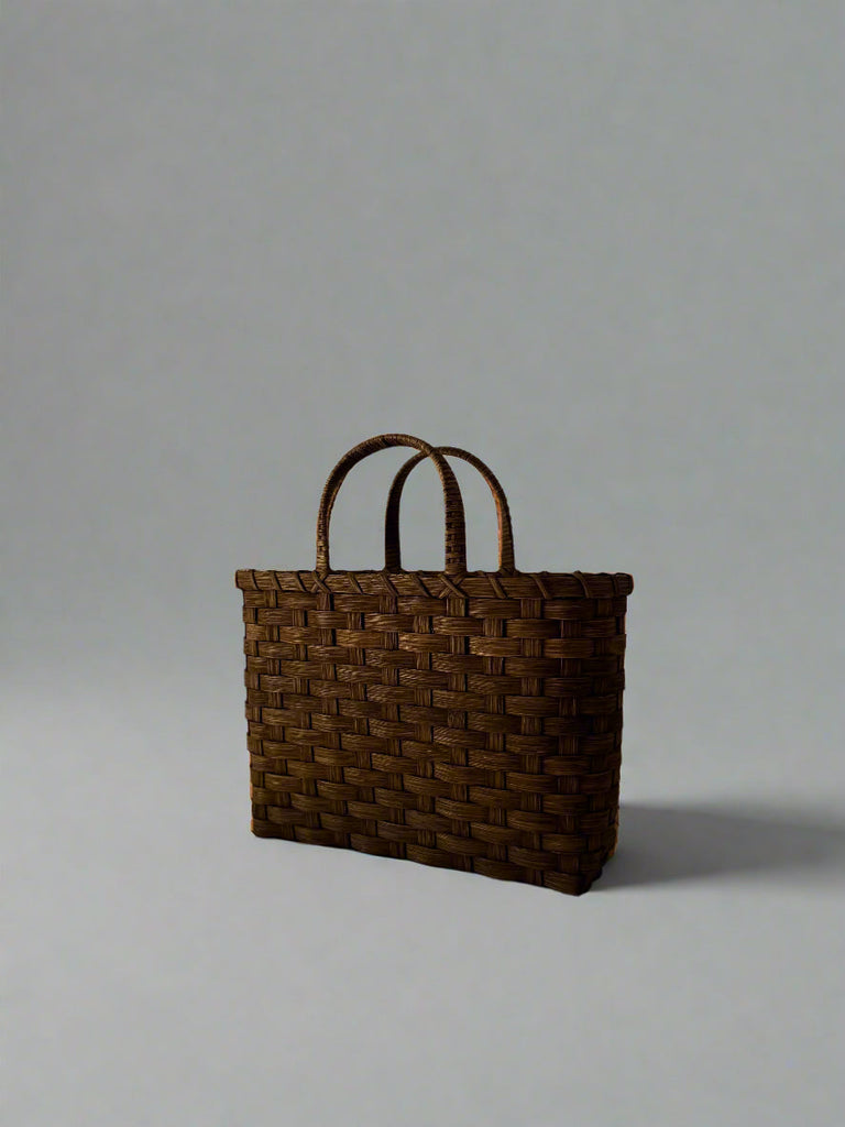 Woven brown bag on a white background