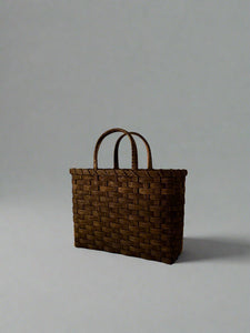 Woven brown bag on a white background